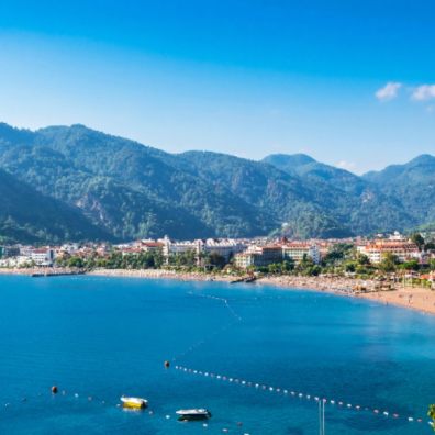 Icmeler bay showing beach and mountains and resort in middle
