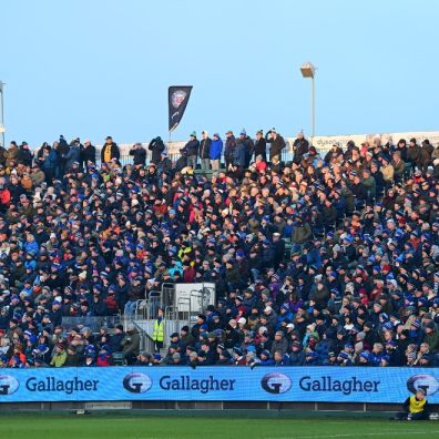 Picture of rugby fans watching premiership rugby Bach showing Gallagher branding