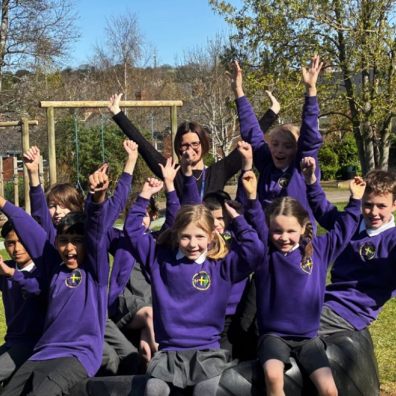 happy pupils in purple uniform celebrating St Sidwells School Exeter ousted report