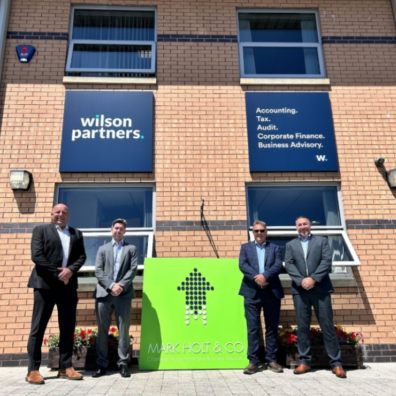 Four Wilson partners stood outside building