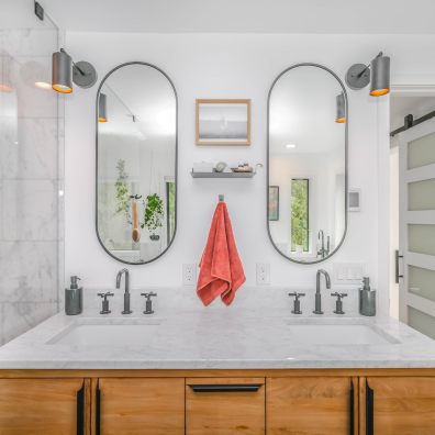 White sink with mirror and silver bathroom accessories.